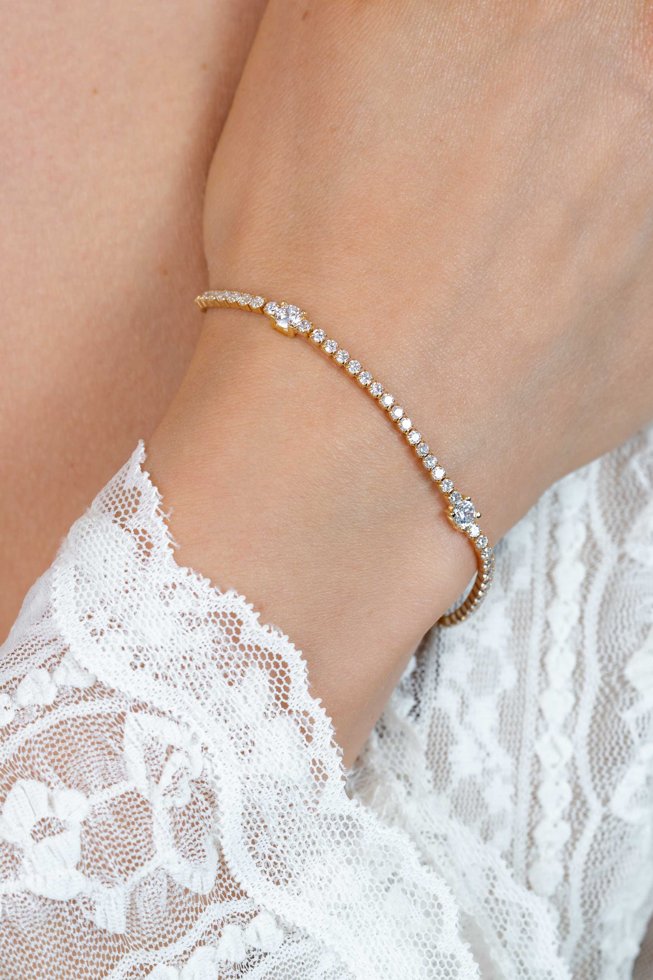 ZINZI gold plated zilveren tennisarmband 2,1mm breed bezet met witte zirkonia’s in verfijnde rijzetting, afgewisseld met drie grotere witte zirkonia's (4,3mm) in chatonzetting ZIA2894Y